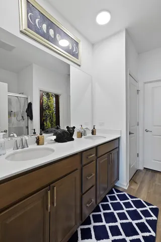 a spacious bathroom with a double vanity sink and mirror