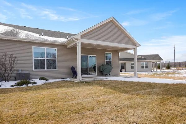 a view of a house with swimming pool and sitting area