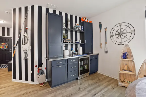 a view of a kitchen with stainless steel appliances granite countertop a refrigerator and a stove top oven