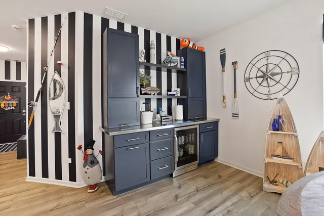 a view of a kitchen with stainless steel appliances granite countertop a refrigerator and a stove top oven