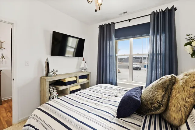 a bedroom with a bed and a flat tv screen