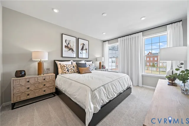 a spacious bedroom with a bed and a window