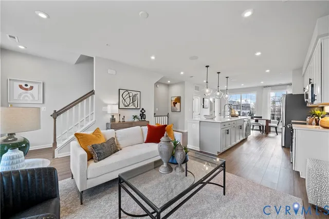 a living room with furniture kitchen view and a table
