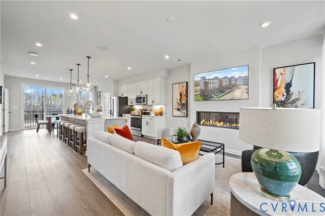 a living room with furniture and kitchen view