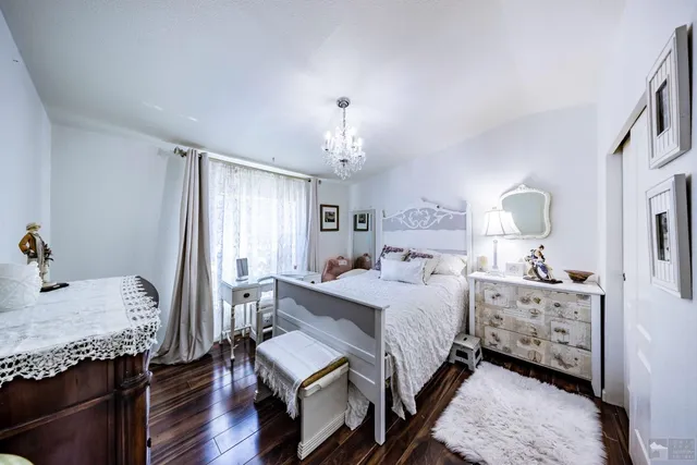 a bathroom with a granite countertop sink a toilet and a mirror