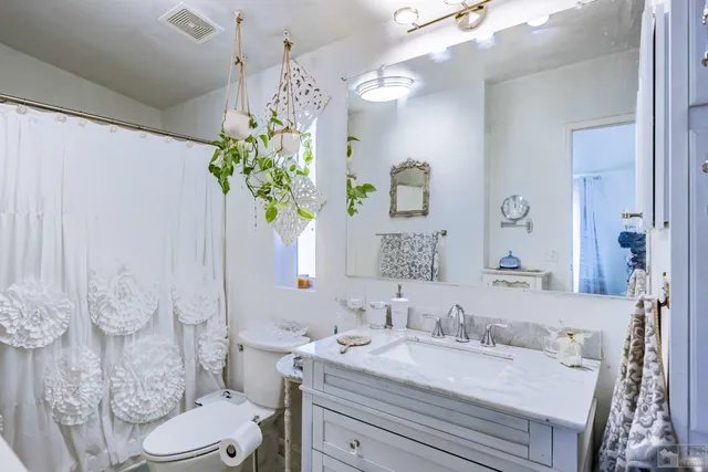 a view of a patio with table and chairs potted plants and large tree