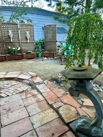 a view of a patio with table and chairs under an umbrella
