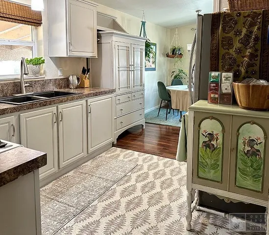 a kitchen with cabinets and window