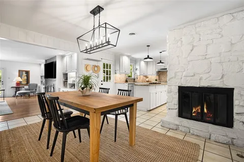 a view of a dining room with furniture and a fireplace