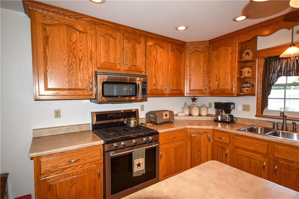 531 White Oak Road Rural Valley, PA 16249 - Photo 13 of 39 a kitchen with stainless steel appliances granite countertop a stove a sink dishwasher and a microwave oven with cabinets