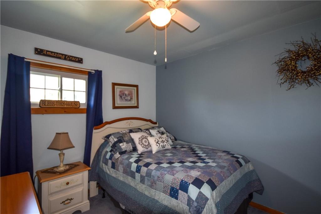 531 White Oak Road Rural Valley, PA 16249 - Photo 18 of 39 a bedroom with a bed and a chandelier