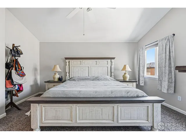 a spacious bedroom with a bed and a chandelier