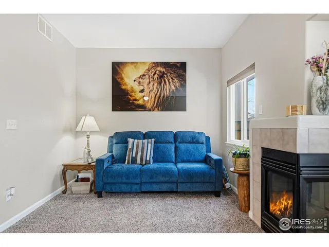 a living room with furniture and a dining table