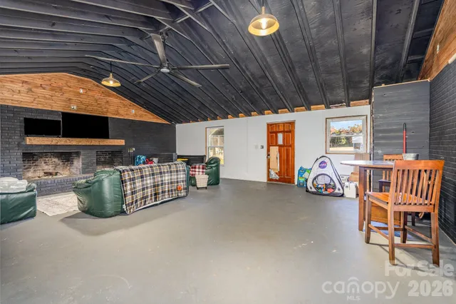 a spacious bedroom with a bed and a flat screen tv