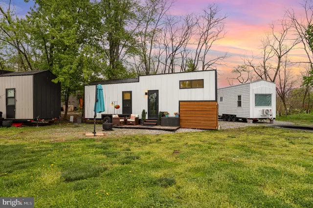 a view of a house with backyard and a tree