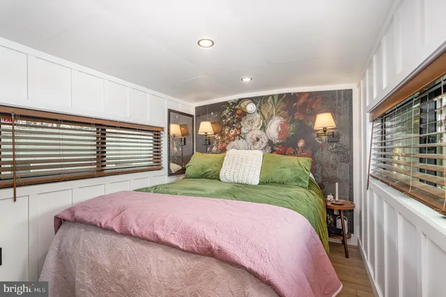 a bedroom with a large bed and a large window