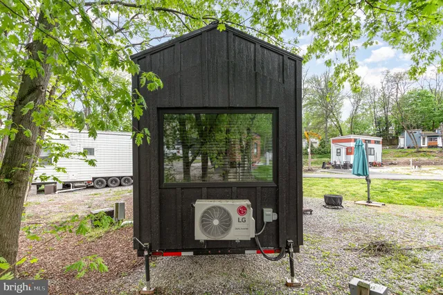 a wooden bench sitting in front of a house