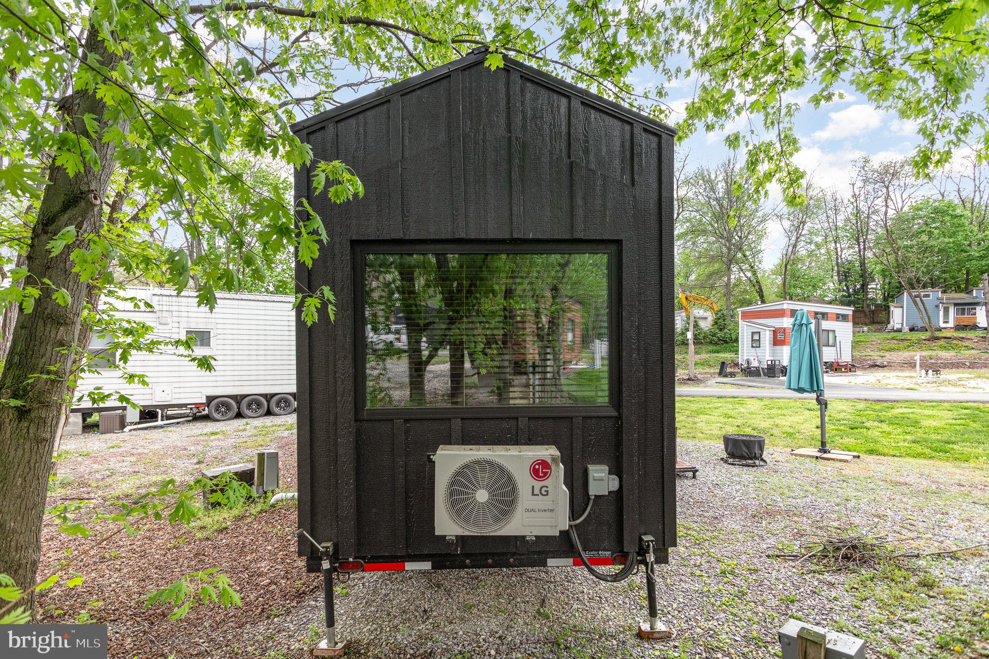 867 Schwanger Road, Unit 14 Elizabethtown, PA 17022 - Photo 19 of 25 a wooden bench sitting in front of a house