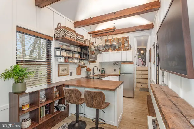 a kitchen with stainless steel appliances granite countertop a stove and a refrigerator