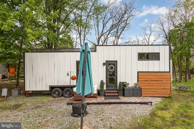 a view of house with backyard and seating area