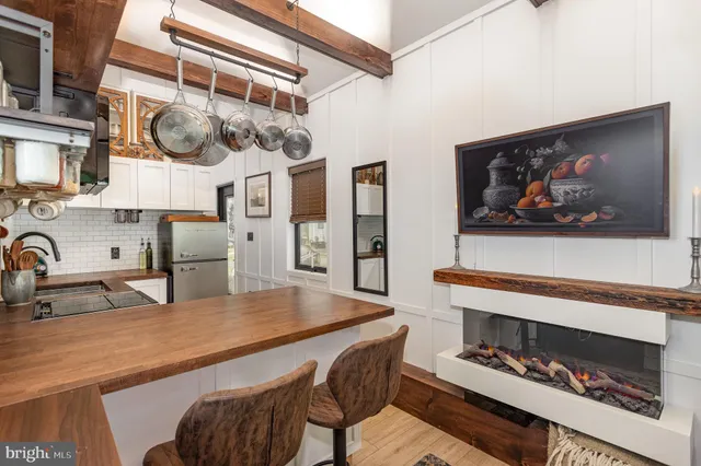 a kitchen with stainless steel appliances kitchen island a stove a sink and a refrigerator