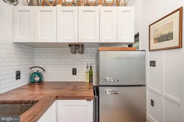 a kitchen with stainless steel appliances white cabinets and a sink
