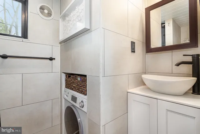 a bathroom with a sink a mirror and a shower