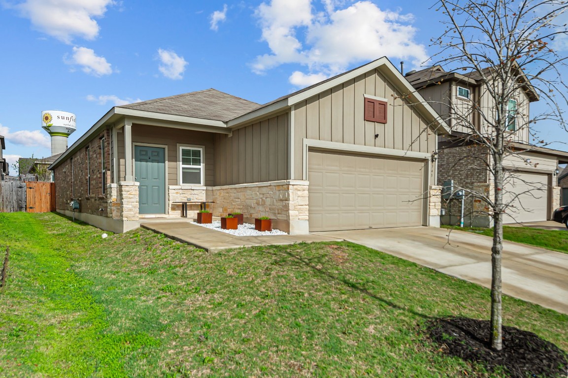 a front view of a house with a yard and garage