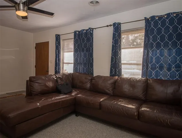 a living room with furniture and a window
