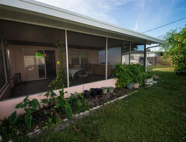 a view of yellow house with a yard