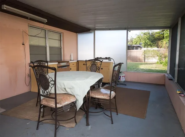 a view of a dining room with furniture and window
