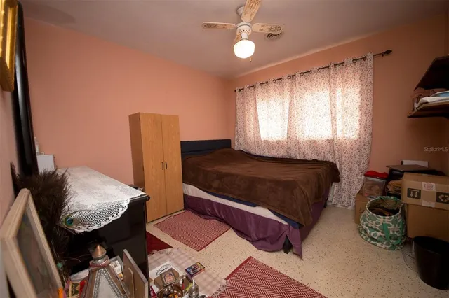 a bedroom with bed and a window