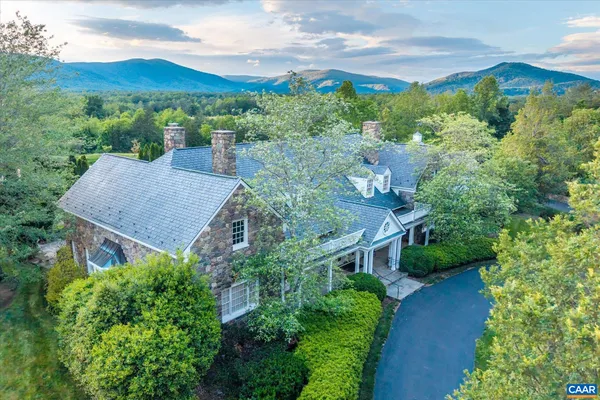 an aerial view of a house with mountain view
