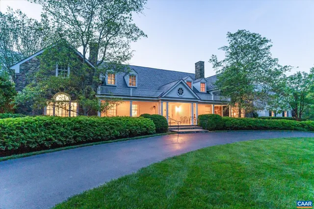 a view of a house with garden and a yard