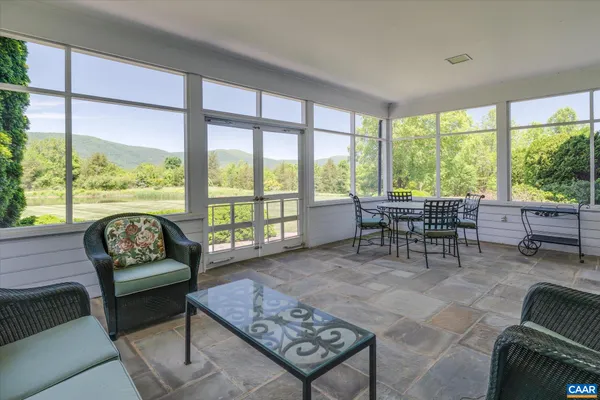 a kitchen with stainless steel appliances granite countertop a sink a stove and a wooden floors