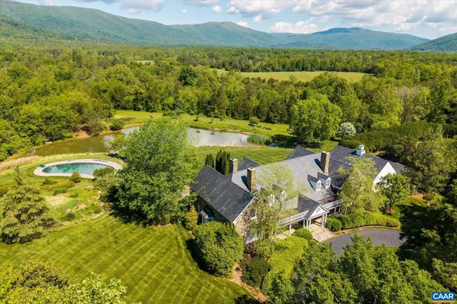 an aerial view of a house with pool