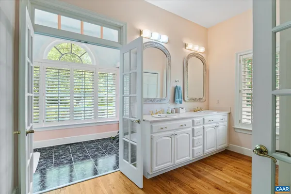 a view of an entryway with wooden floor and windows