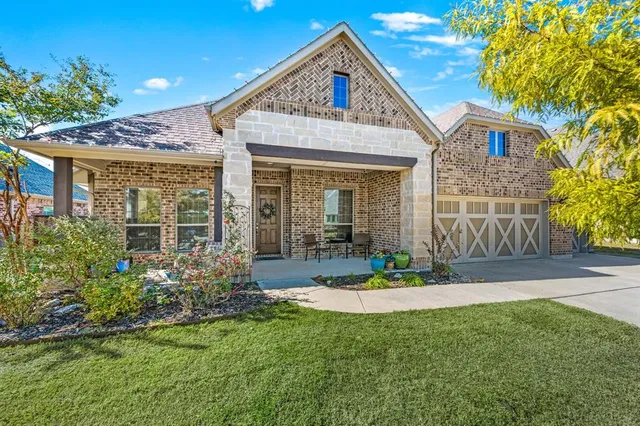 a view of a brick house with a yard