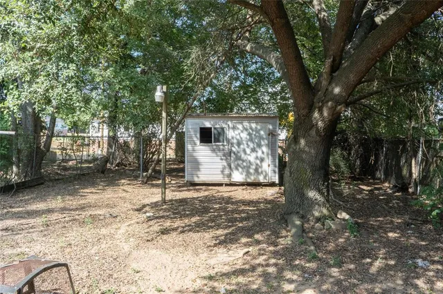a white house that has a tree in front of it