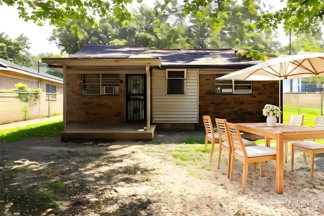 a patio with table and chairs