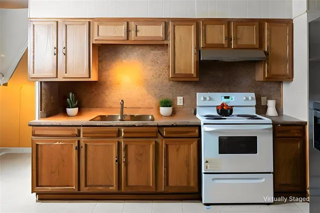 a kitchen with stainless steel appliances granite countertop a sink and a stove