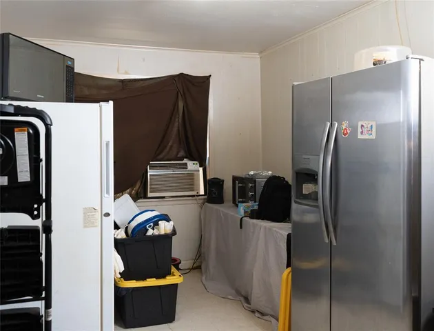 a kitchen with refrigerator and window