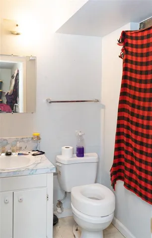 a white toilet sitting next to a sink and vanity