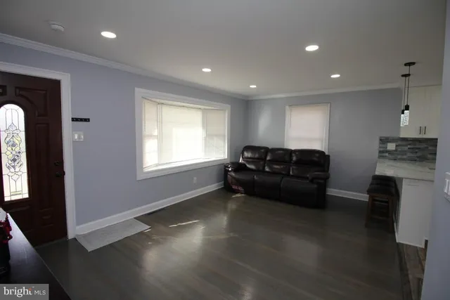 a kitchen with a sink window and cabinets