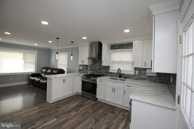 a kitchen with granite countertop white cabinets stainless steel appliances and sink