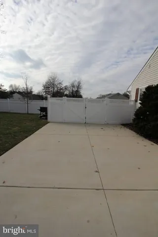 a view of a yard in the front of a house
