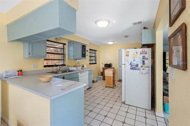 a kitchen with a sink appliances and cabinets