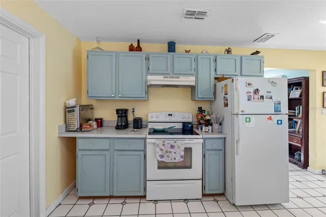 a kitchen with stainless steel appliances granite countertop a refrigerator and a stove