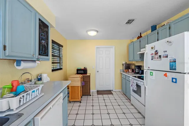 a kitchen with stainless steel appliances a stove a sink and cabinets