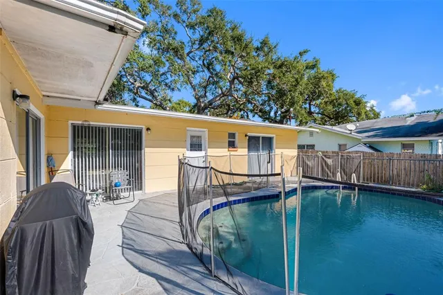 a view of a house with backyard and sitting area
